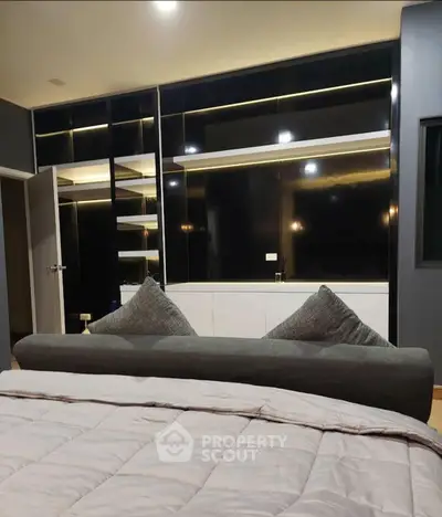 Luxurious bedroom with modern black cabinetry and cozy bedding