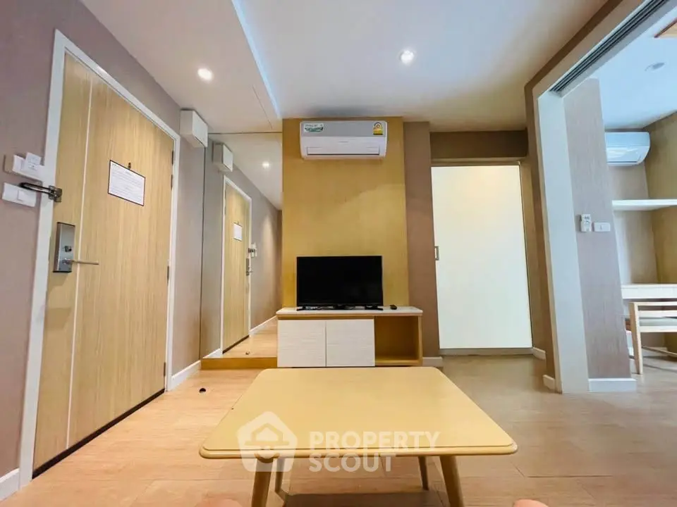 Modern living room with air conditioning and wooden furniture in a cozy apartment.