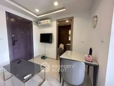 Modern living room with sleek furniture and wall-mounted TV