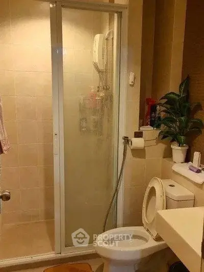 Compact bathroom with shower enclosure and modern fixtures.