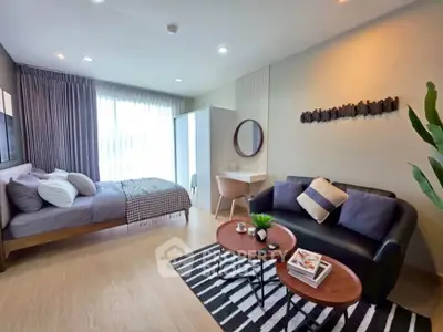 Modern studio apartment with cozy living area and stylish decor