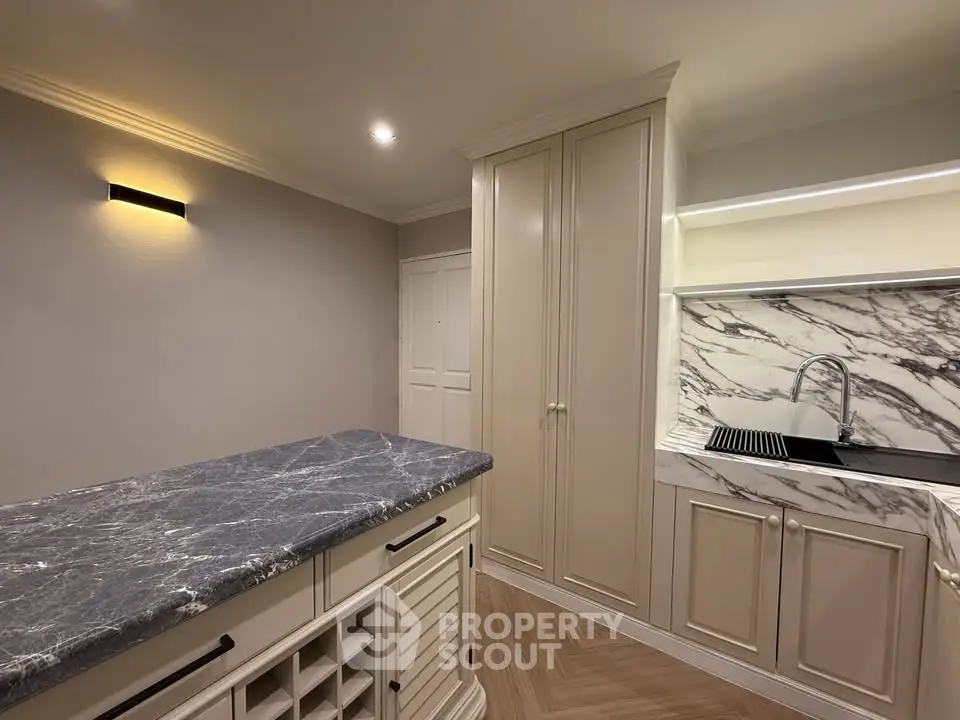 Elegant kitchen with marble countertops and modern cabinetry