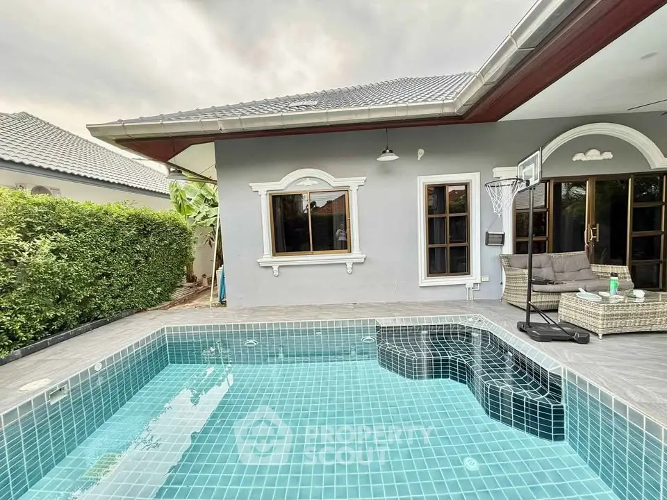 Charming villa with private pool and cozy outdoor seating area, perfect for relaxation and entertainment.