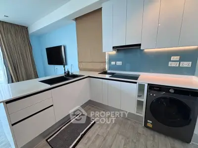 Modern kitchen with sleek cabinetry and built-in appliances in a stylish apartment.