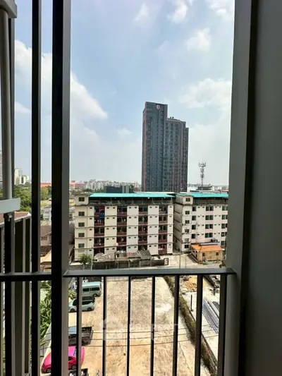 Urban apartment view with high-rise building and parking area