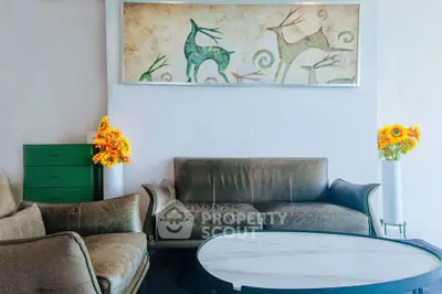 Stylish living room with leather sofas, modern art, and vibrant floral decor