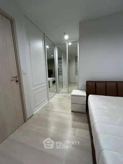 Modern bedroom with mirrored closet and sleek design