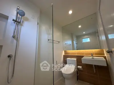 Modern bathroom with glass shower and sleek fixtures