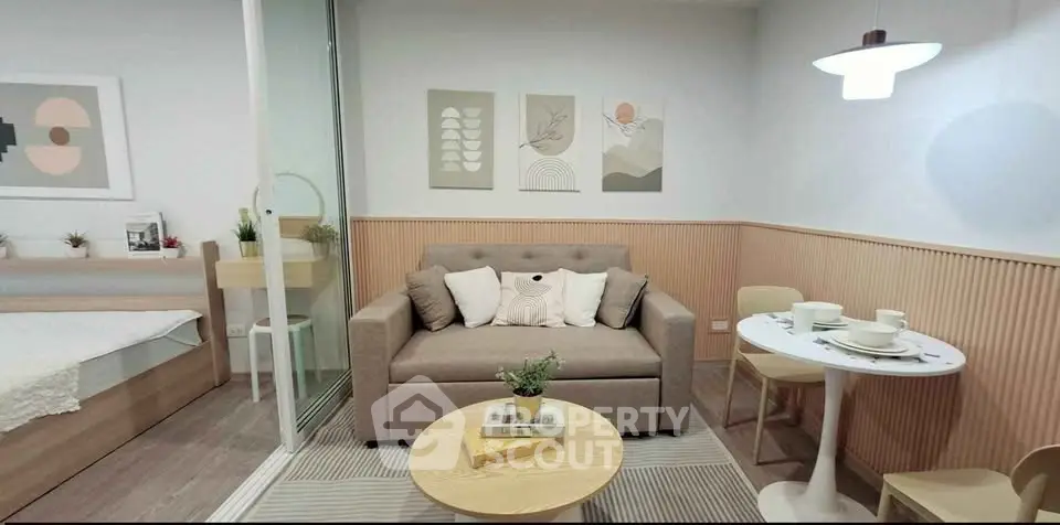 Chic modern living room with cozy sofa, stylish decor, and dining area in open-plan layout.
