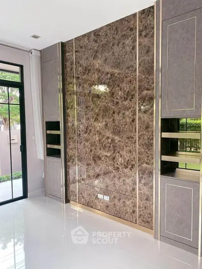 Luxurious modern living room with marble accent wall and large windows