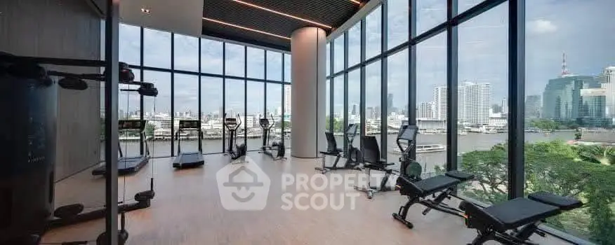 Luxurious gym with panoramic city views and modern fitness equipment in a high-rise building.