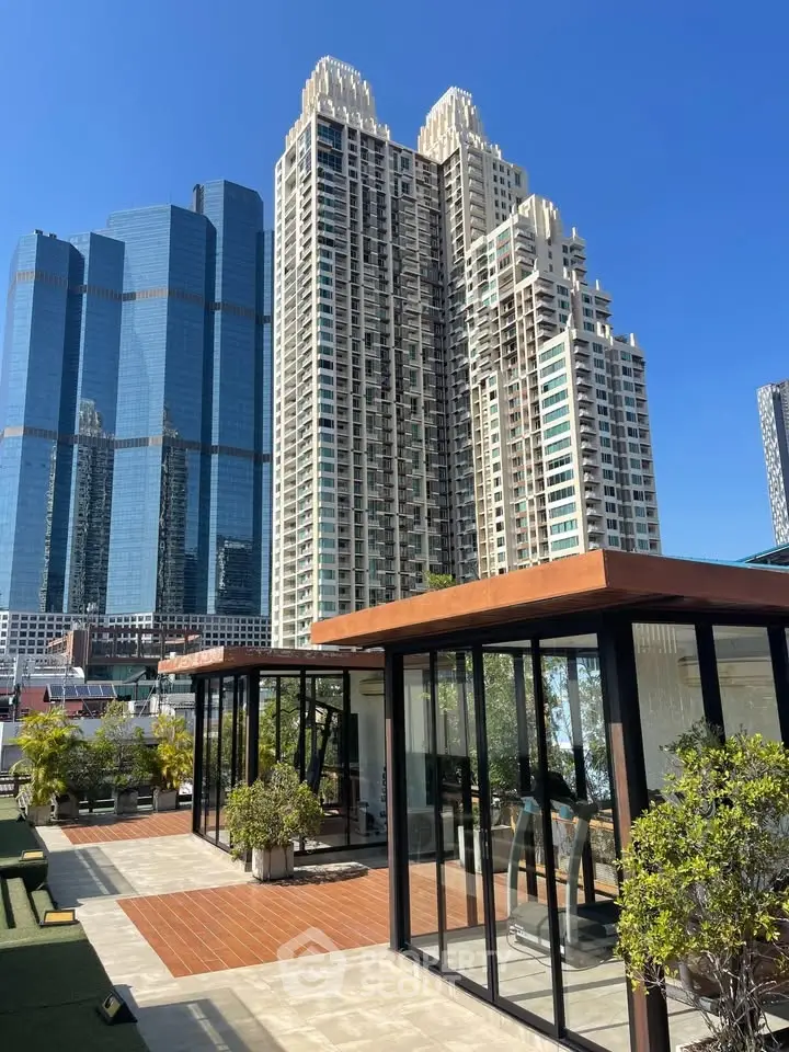 Luxurious rooftop view with modern glass structure and stunning cityscape backdrop.