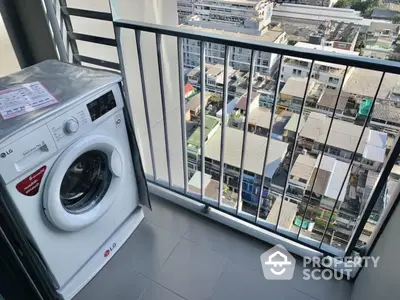 High-rise balcony with washing machine and city view