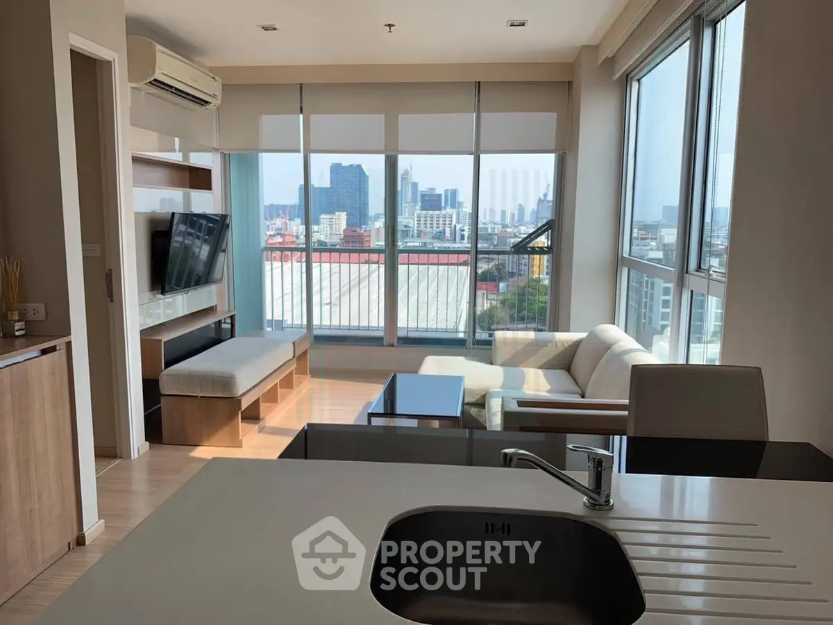 Modern living room with panoramic city view, stylish furniture, and open layout in high-rise apartment.