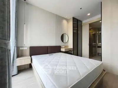 Modern bedroom with minimalist design and large windows for natural light.