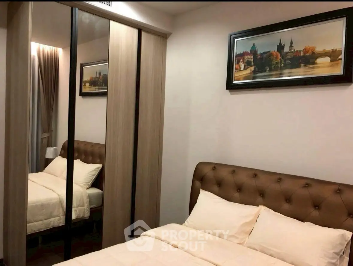 Cozy bedroom with mirrored wardrobe and elegant decor