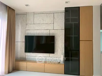 Modern living room with sleek TV setup and elegant cabinetry