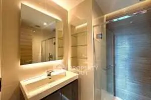 Modern bathroom with sleek design and illuminated mirror