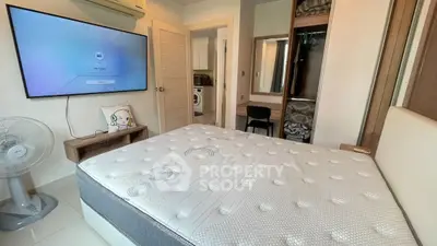 Modern bedroom with wall-mounted TV and stylish decor