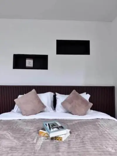 Cozy bedroom with stylish decor and plush bedding, perfect for relaxation.