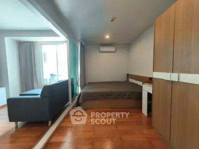 Modern studio apartment with wooden flooring and cozy furnishings