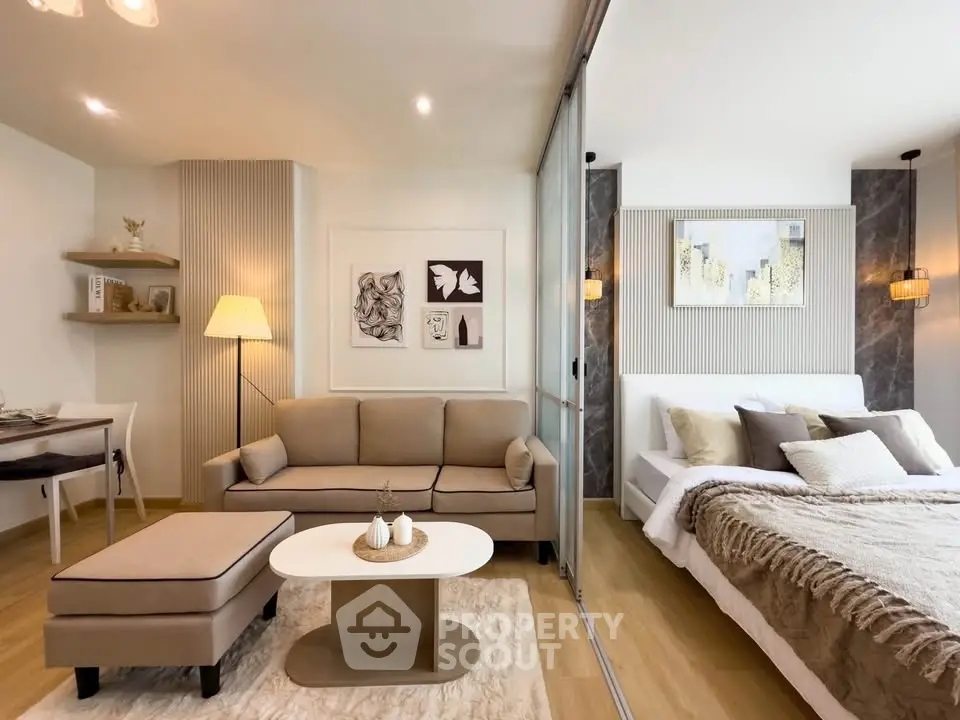 Modern open-plan living room and bedroom with stylish decor and neutral tones