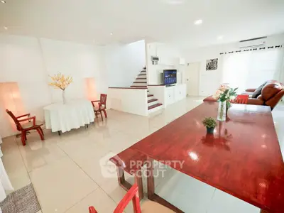 Spacious living room with elegant furniture and modern decor, perfect for family gatherings.
