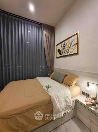 Cozy bedroom with modern decor and large window draped with elegant curtains.