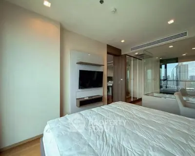 Modern bedroom with city view, featuring sleek design and large windows for natural light.