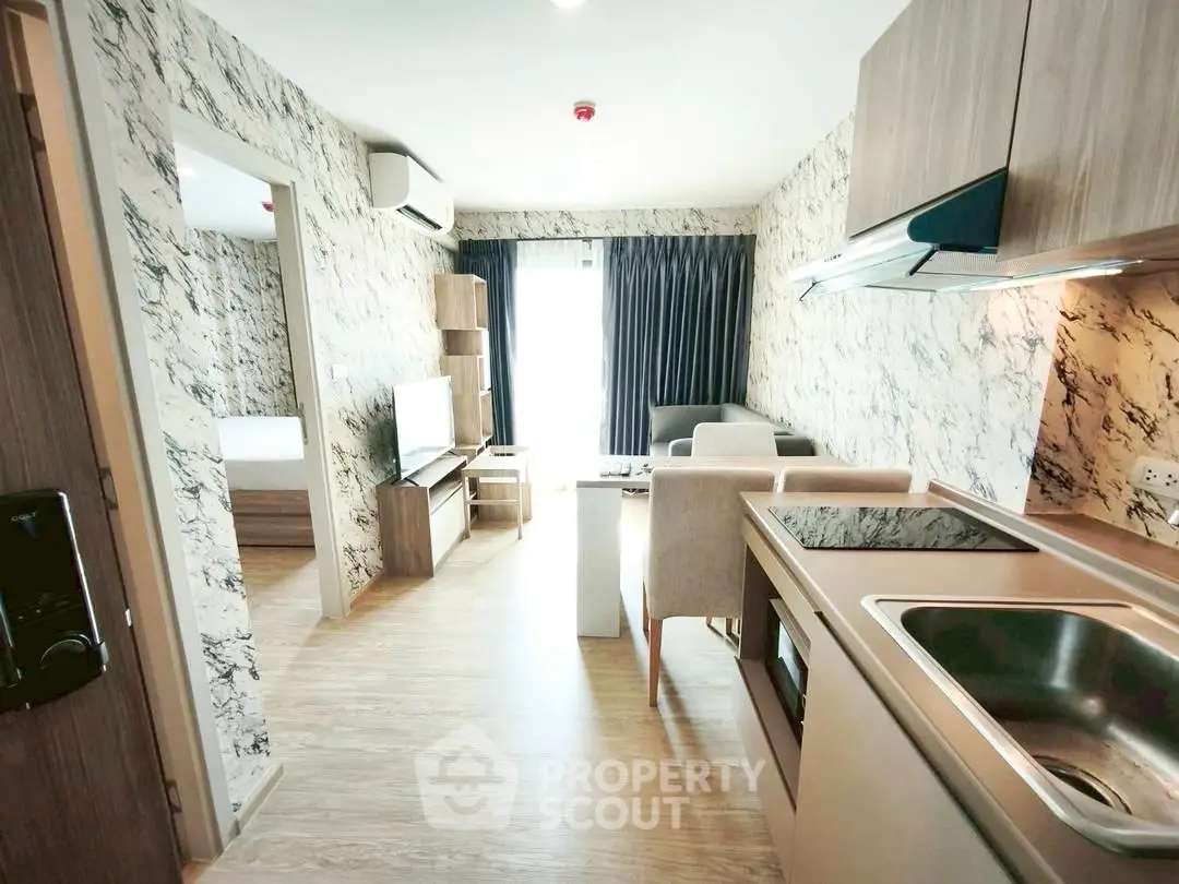 Modern open-plan living room with stylish kitchen and marble accents