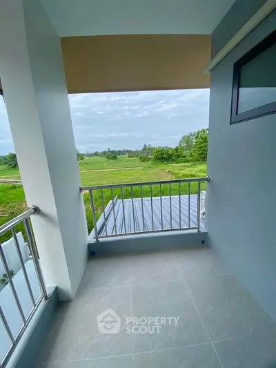 Charming balcony with serene countryside view, perfect for relaxation and enjoying nature's beauty.