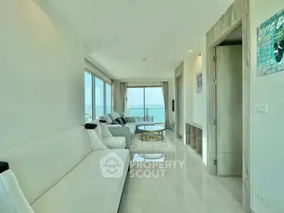 Luxurious living room with stunning ocean view and elegant white sofas