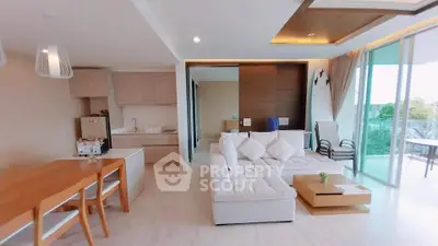 Spacious modern living room with open kitchen and large balcony view