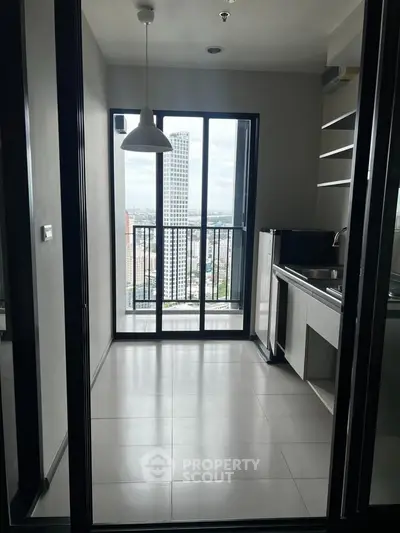 Modern kitchen with city view and sleek design in high-rise apartment