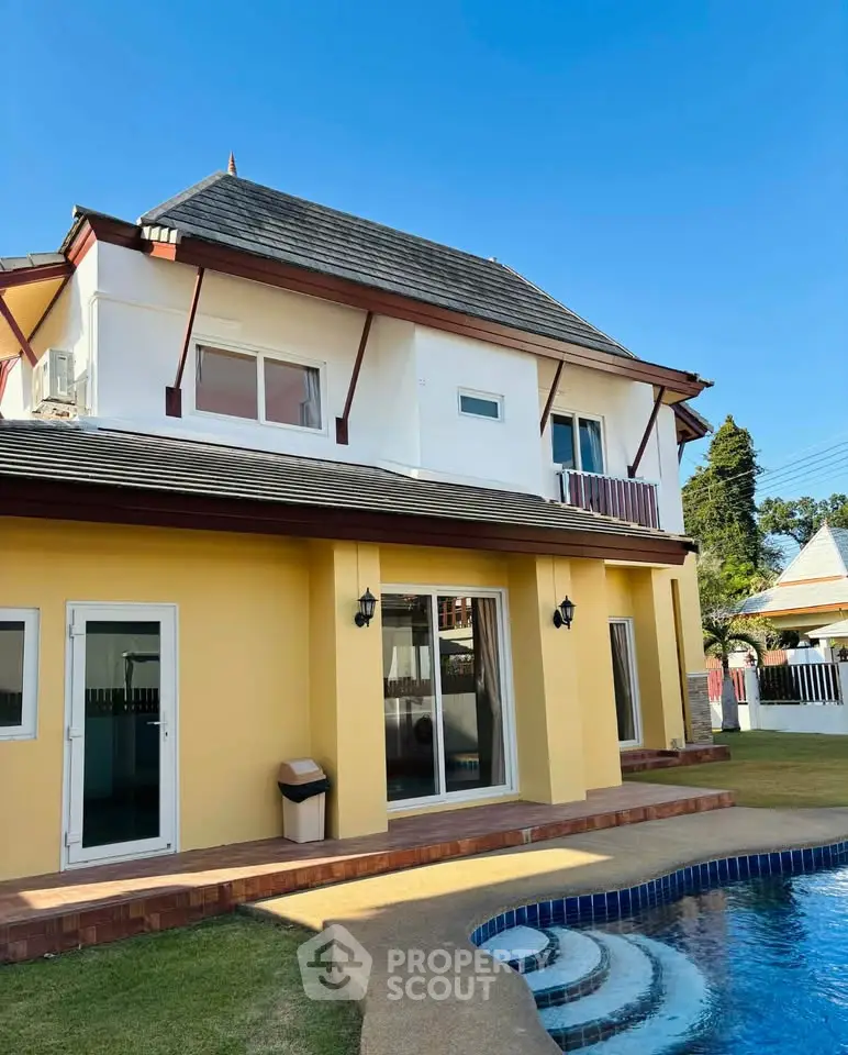 Charming two-story home with pool and elegant architectural design.