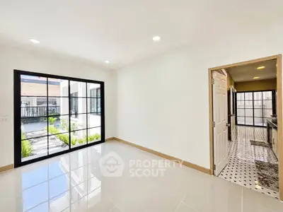 Bright interior with large windows and modern kitchen view