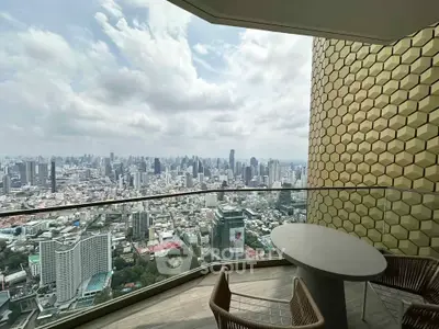 Stunning cityscape view from a high-rise balcony with modern seating, perfect for urban living.