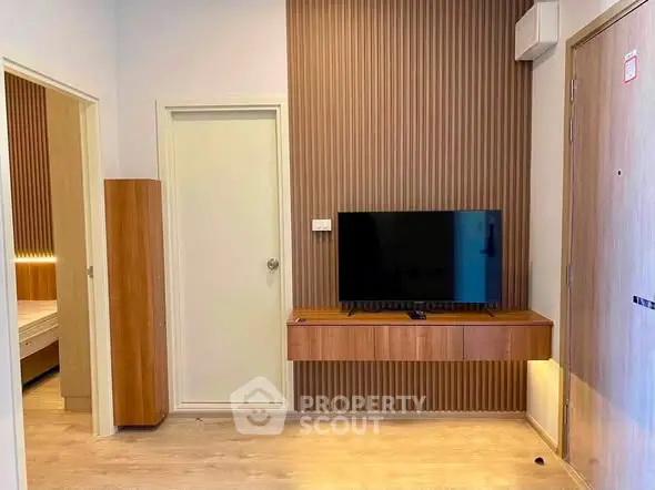 Modern living room with wall-mounted TV and wooden accents