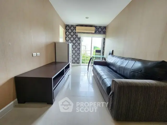 Modern living room with sleek furniture and large window view