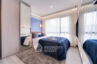 Modern bedroom with stylish decor and large windows for natural light