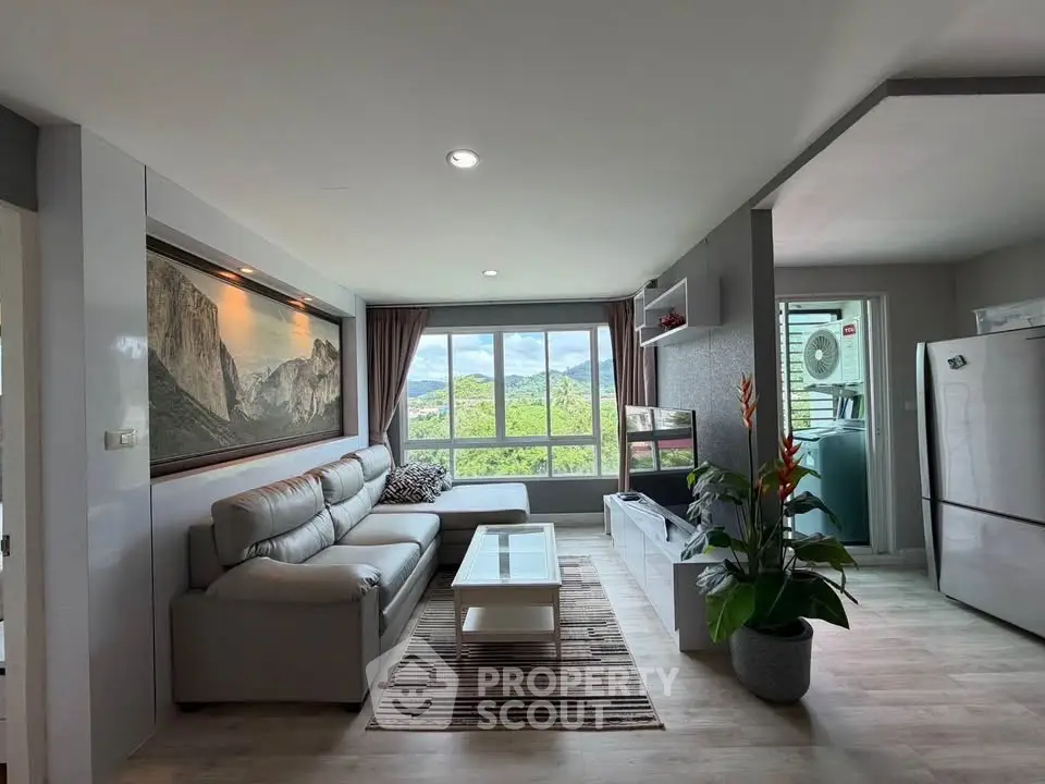 Spacious living room with modern decor and scenic window view in a stylish apartment.