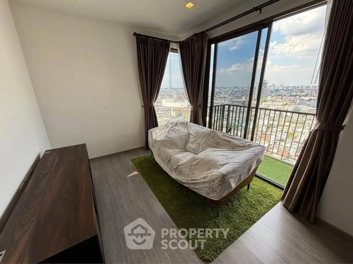 Spacious room with large windows offering stunning city views and natural light.