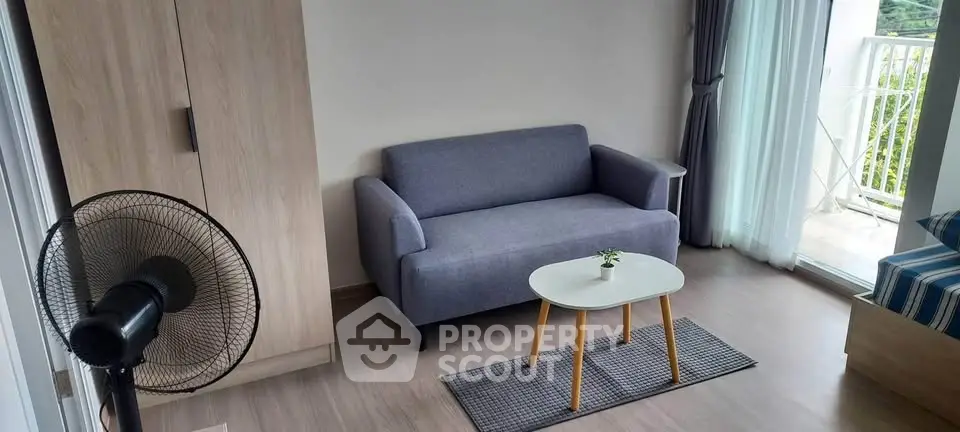 Cozy living room with modern sofa and balcony view