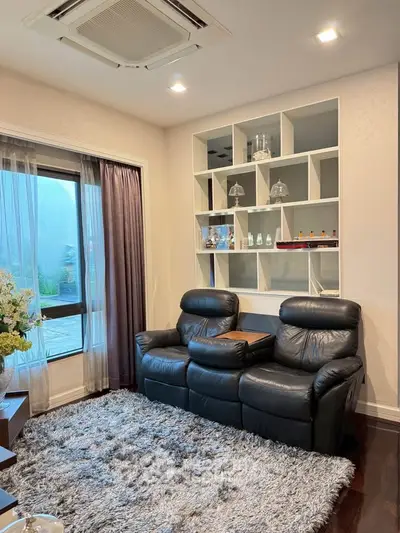 Cozy living room with plush seating and modern decor, featuring a stylish built-in shelf.