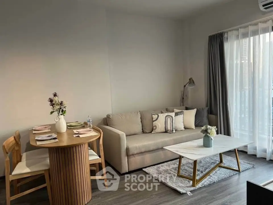 Modern living room with cozy sofa, stylish coffee table, and dining area in a bright apartment.