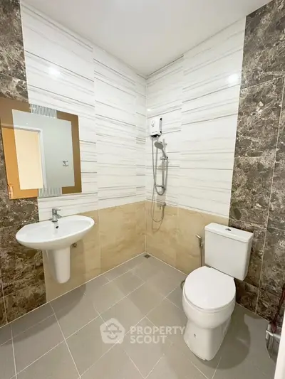 Modern bathroom with stylish tiles and sleek fixtures in a contemporary apartment.