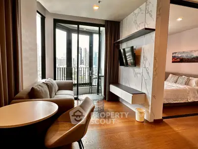 Modern apartment with open living room and bedroom, featuring city view balcony.