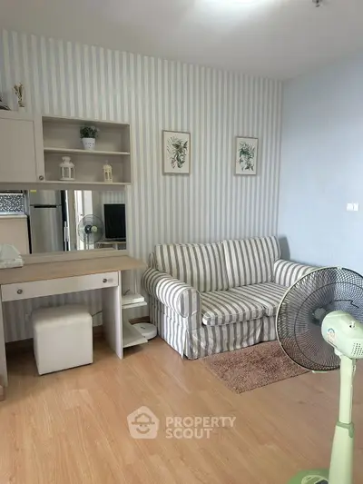 Charming living room with striped sofa and stylish decor in cozy apartment