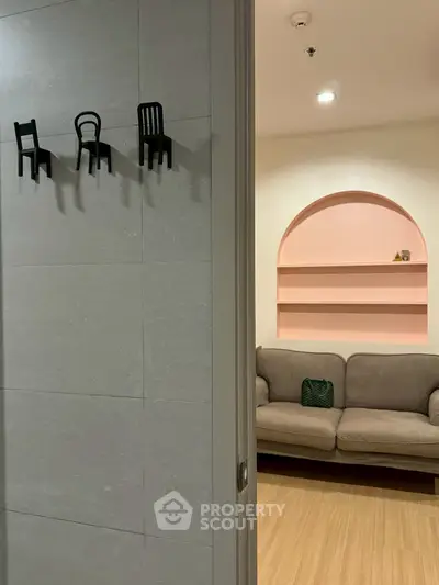 Stylish living room with unique wall decor and cozy sofa, perfect for modern living.