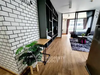 Stylish modern apartment with open layout and wooden flooring, featuring a cozy living area and large windows.